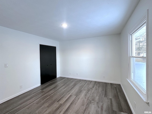 spare room featuring dark hardwood / wood-style floors