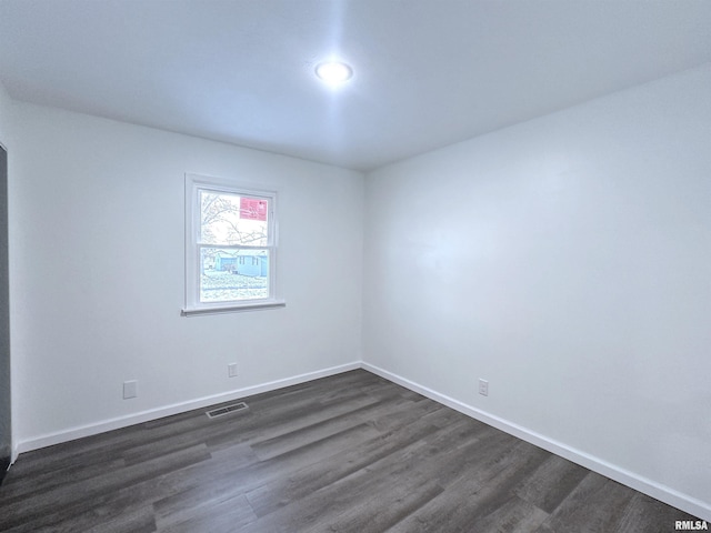 unfurnished room featuring dark hardwood / wood-style floors