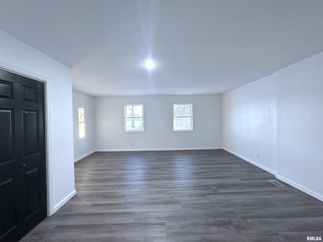 empty room featuring dark hardwood / wood-style flooring