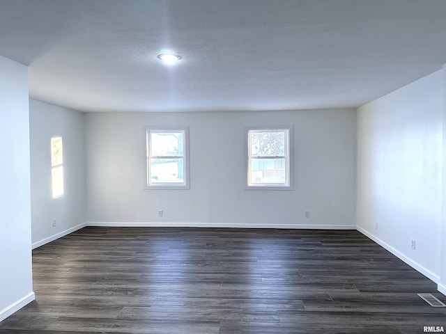 empty room with dark hardwood / wood-style floors