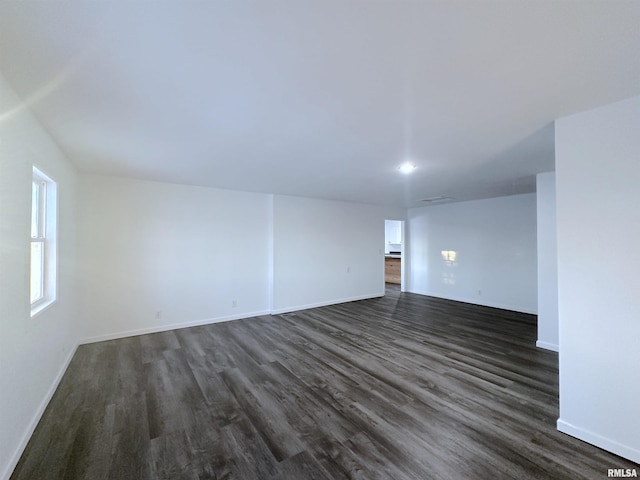 spare room with dark hardwood / wood-style floors