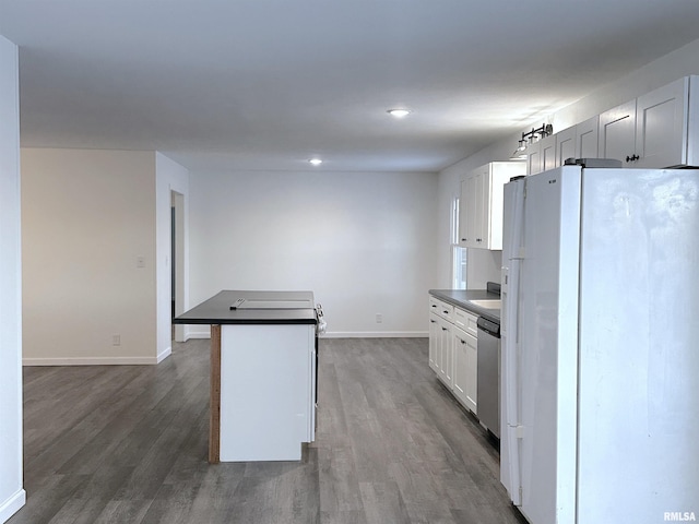 kitchen featuring dishwasher, a kitchen island, dark hardwood / wood-style floors, white fridge, and white cabinets