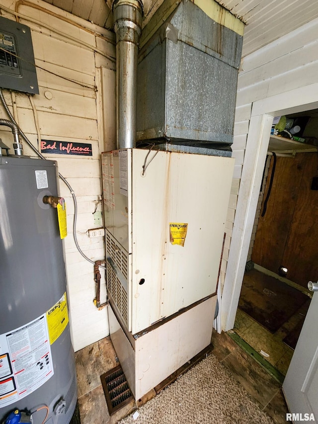 utility room featuring gas water heater and heating unit