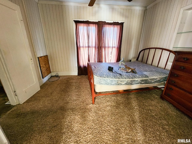 bedroom featuring dark colored carpet, ceiling fan, and crown molding