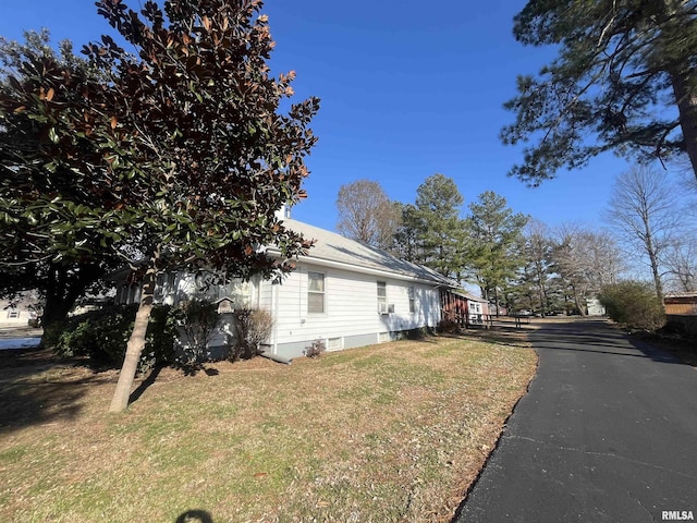 view of side of property with a yard