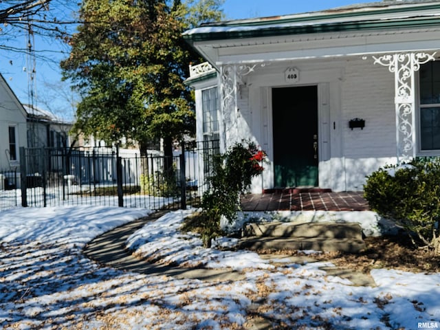 view of snow covered property entrance