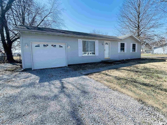 single story home featuring an attached garage, driveway, and fence