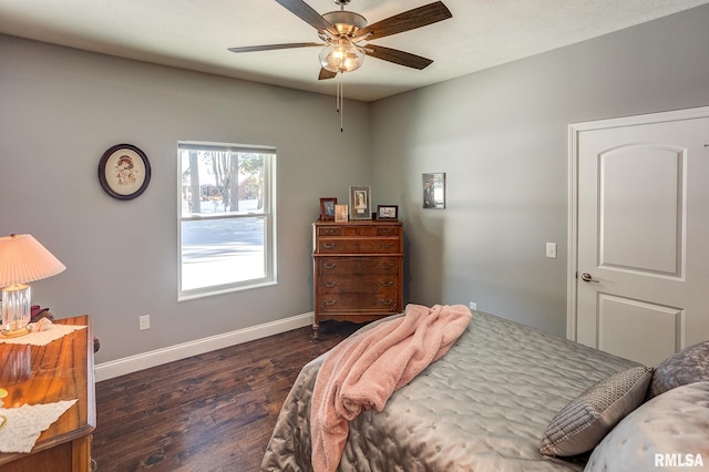 bedroom with ceiling fan and dark hardwood / wood-style flooring