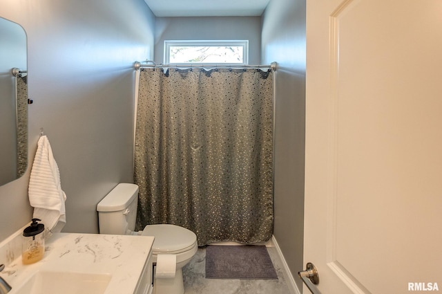 bathroom featuring toilet, walk in shower, and vanity