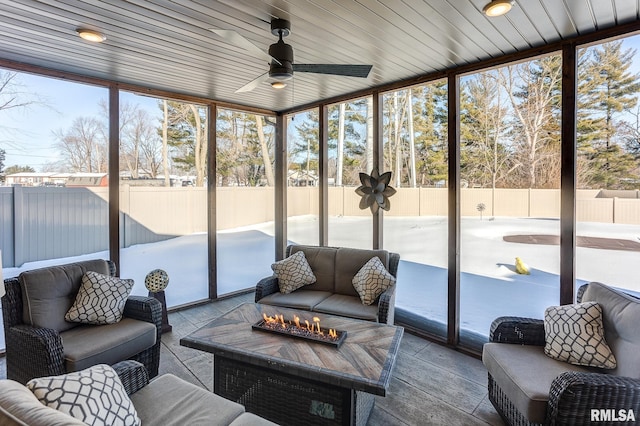 sunroom / solarium featuring ceiling fan