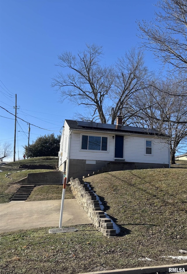 view of front of house featuring solar panels