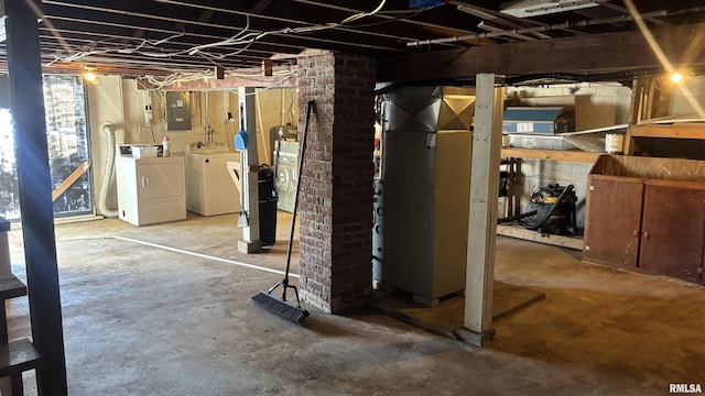 basement featuring electric panel and washer and clothes dryer