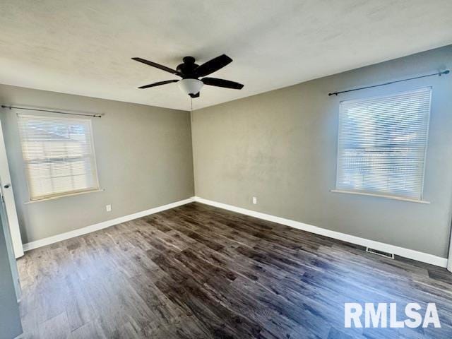 empty room featuring ceiling fan and dark hardwood / wood-style flooring