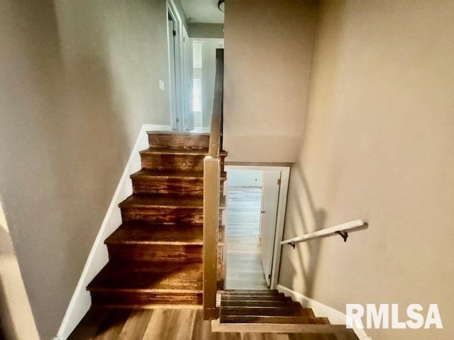 staircase featuring hardwood / wood-style flooring