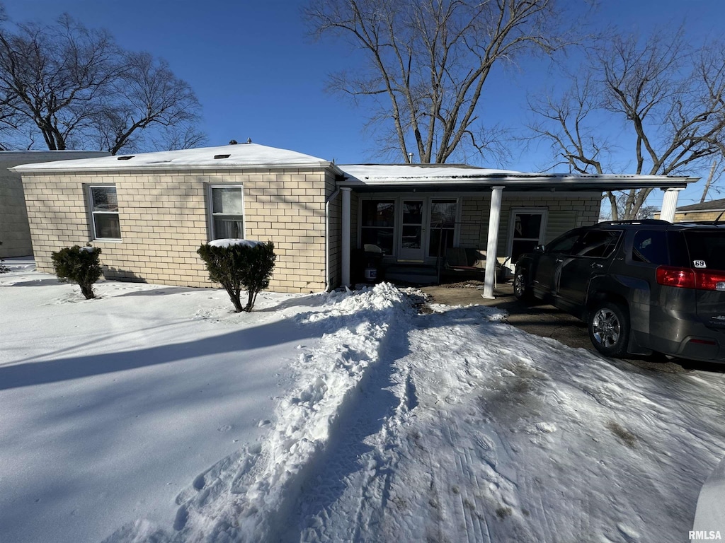 ranch-style home with a carport