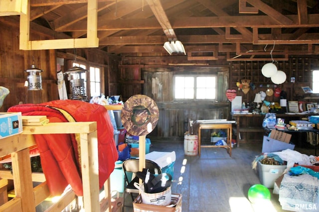 interior space with hardwood / wood-style floors and wooden walls