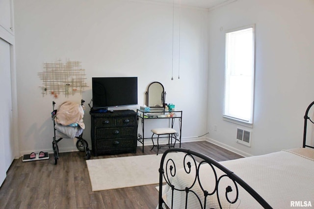 bedroom featuring dark wood-type flooring and ornamental molding