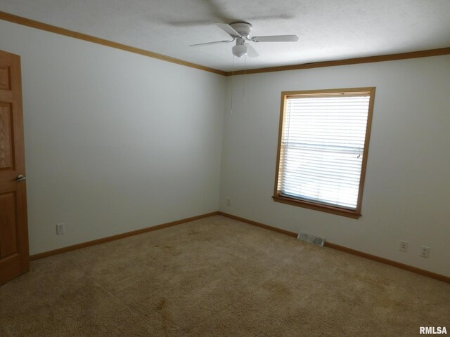 carpeted empty room featuring crown molding and ceiling fan