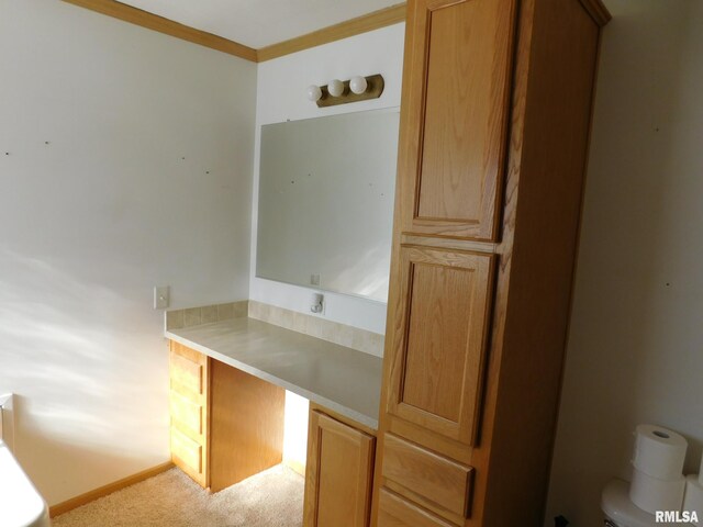 bathroom with crown molding and toilet