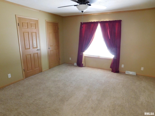 carpeted empty room with ceiling fan