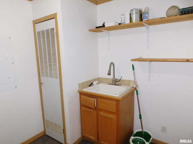 laundry room featuring sink and electric panel