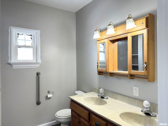 bathroom featuring toilet and vanity