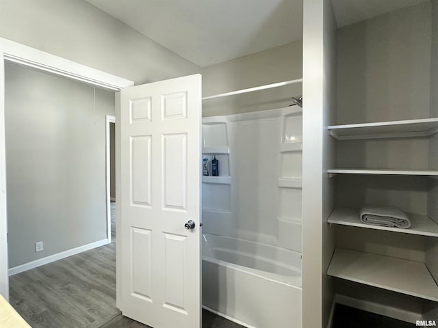 bathroom featuring tub / shower combination and hardwood / wood-style flooring