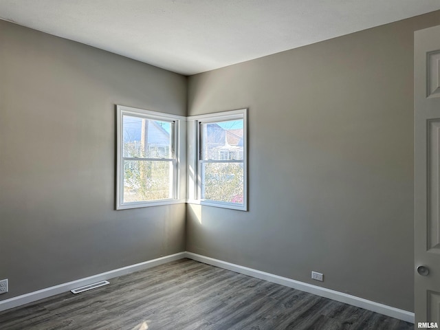 spare room with dark wood-type flooring