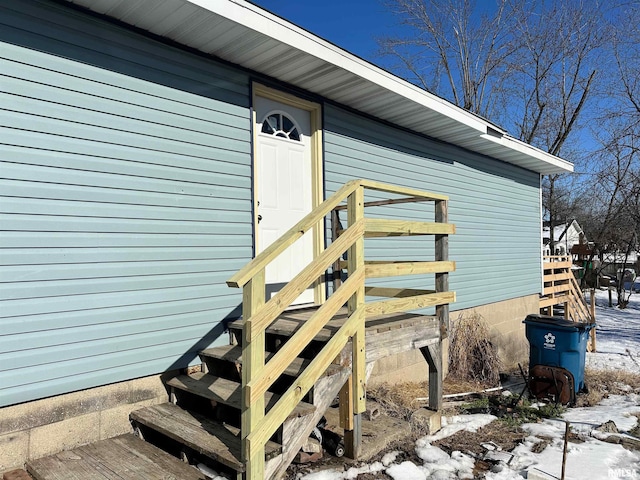 view of snow covered property entrance