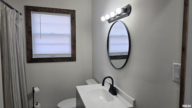 bathroom featuring toilet and vanity