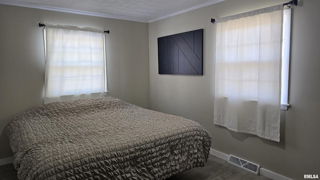 bedroom featuring multiple windows and dark hardwood / wood-style flooring