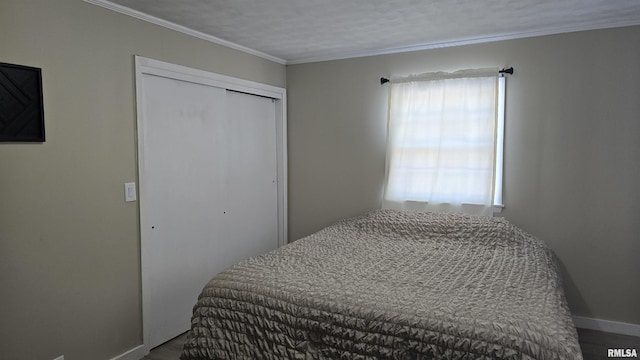 bedroom with a textured ceiling, a closet, and ornamental molding