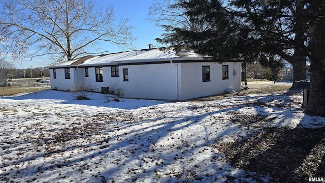 view of snow covered rear of property