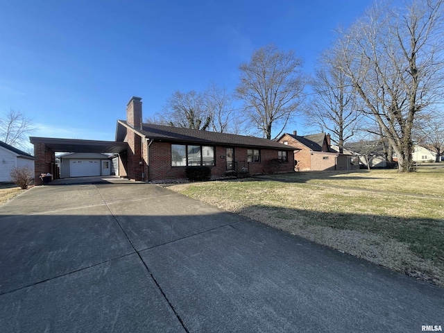 ranch-style home featuring a carport, a garage, and a front lawn