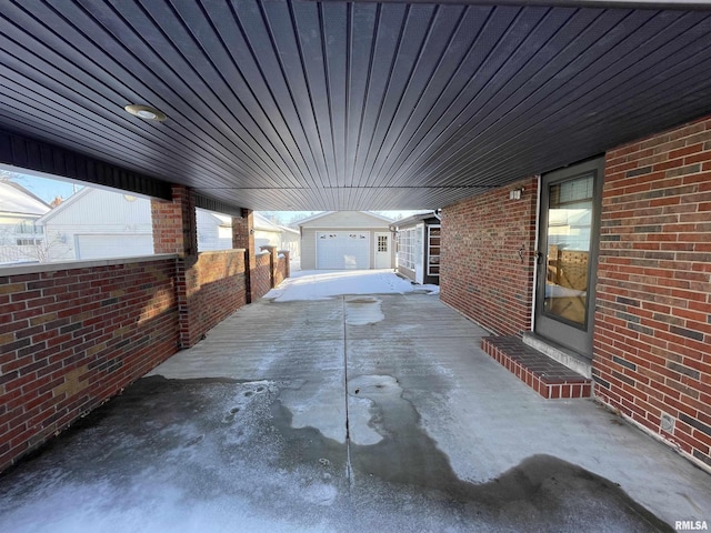 view of patio with a garage and an outdoor structure