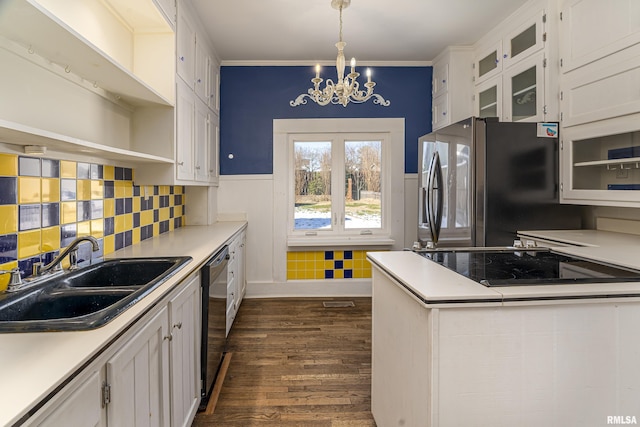 kitchen featuring an inviting chandelier, hanging light fixtures, black appliances, white cabinets, and sink