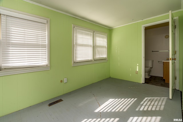 unfurnished bedroom with ensuite bath and crown molding