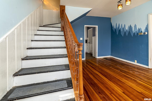 stairway with a textured ceiling