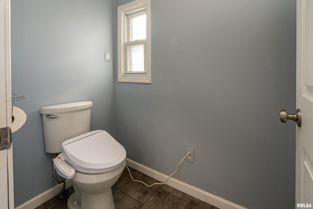 bathroom featuring toilet and tile patterned flooring