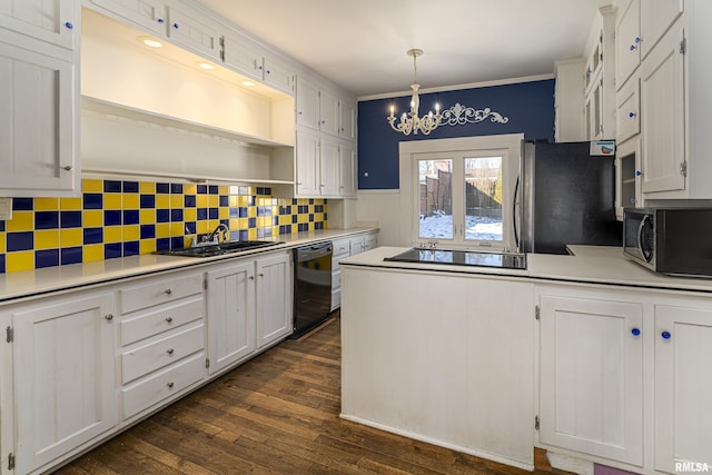 kitchen with black appliances, decorative light fixtures, white cabinetry, sink, and a notable chandelier