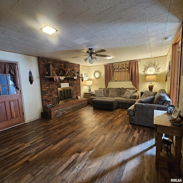 living room with ceiling fan, dark wood-type flooring, and a fireplace