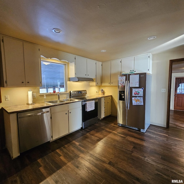 kitchen featuring dark hardwood / wood-style flooring, sink, stainless steel appliances, and white cabinetry