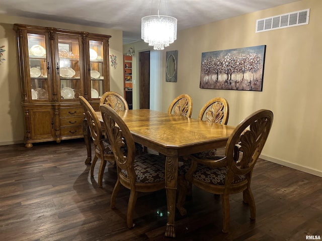 dining space featuring a chandelier and dark hardwood / wood-style floors