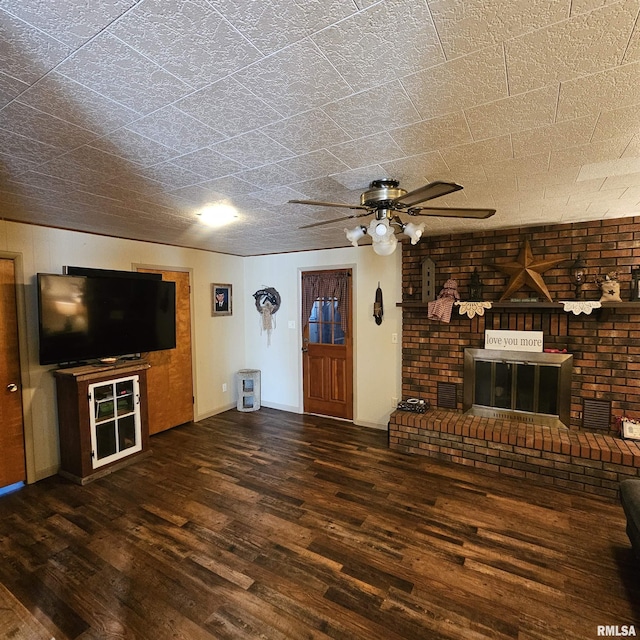 unfurnished living room with a brick fireplace, dark hardwood / wood-style flooring, and ceiling fan