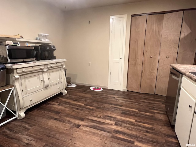 kitchen featuring appliances with stainless steel finishes and dark hardwood / wood-style floors