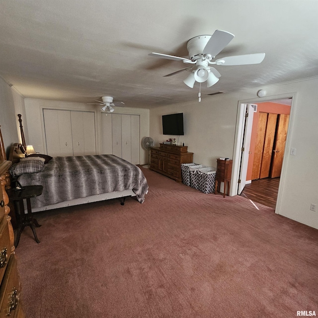 bedroom featuring ceiling fan and dark carpet