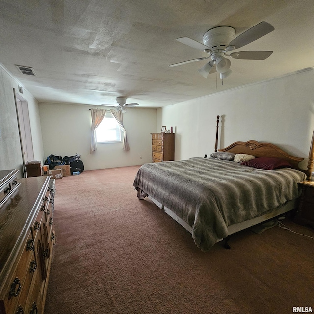 bedroom with ceiling fan, dark carpet, and a textured ceiling