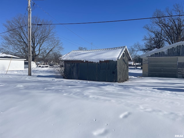 snow covered structure with an outdoor structure