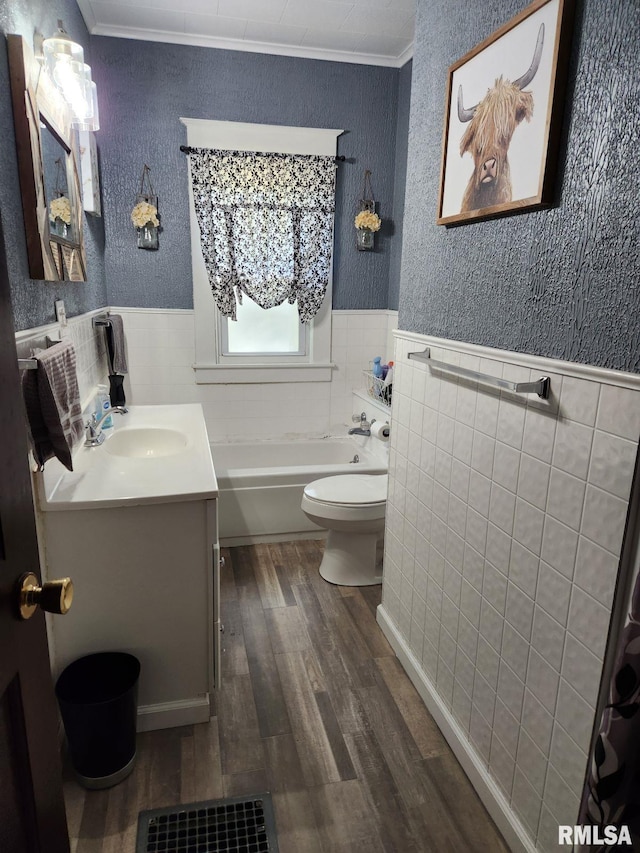 bathroom featuring toilet, hardwood / wood-style floors, crown molding, a washtub, and vanity