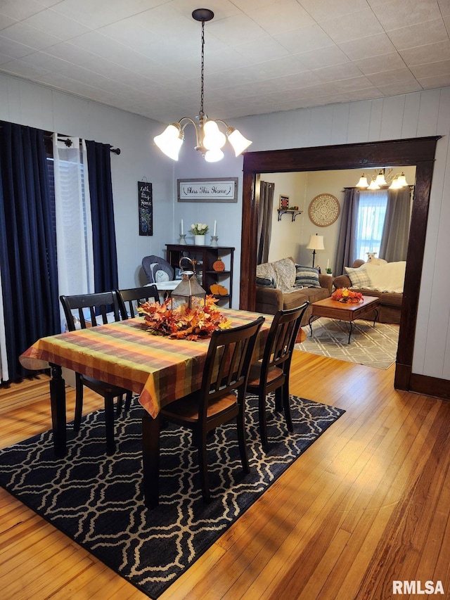 dining area featuring a notable chandelier and hardwood / wood-style floors